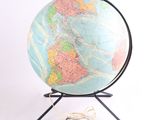 a globe on a stand on a white background