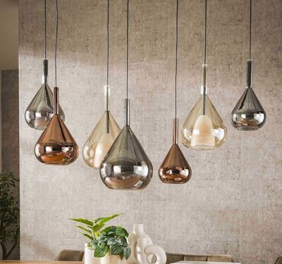 five lights hanging from the ceiling above a dining room table