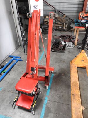 a red lift truck that is parked in a garage