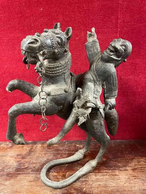 a statue of a man riding a horse on a wooden table