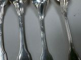 five spoons that are sitting next to each other