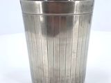 a metal trash can that is sitting on a table