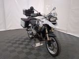 a motorcycle that is parked in a room with a checkered floor
