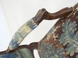 a close up of a chair with a blue and brown upholstered upholstered seat
