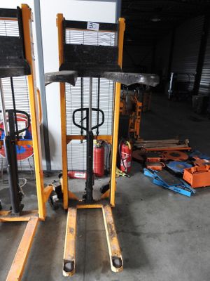 two forklifts that are sitting in a garage