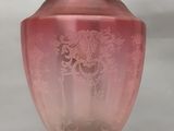 une lampe en verre rose suspendue au plafond par une chaîne