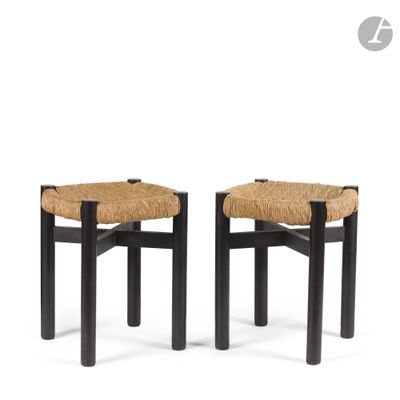a pair of black stools with a woven seat