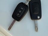 two keys that are sitting on top of a white car