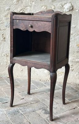a small wooden table with a drawer on top of it