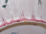 a close up view of a vase with a butterfly on it
