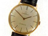 an image of a gold watch with a black strap