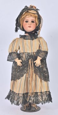 an image of a doll is dressed in a dress and bonnet