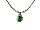 an image of a necklace with a green stone surrounded by diamonds