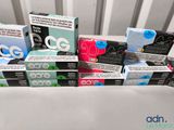 several boxes of cigarettes sitting on top of a table next to each other