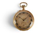 a gold pocket watch with roman numerals on the face