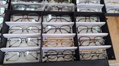 many pairs of glasses in a box on a table