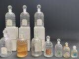 several bottles of different types and sizes of perfumes on a table