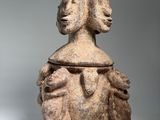 an image of a stone statue of a woman with a bird on her head