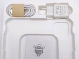 a white tray with a phone and a charger on it