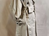 a woman ' s trench coat on a mannequin mannequin mannequin mannequin mannequin mannequin mannequin mannequin