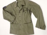 an army green jacket with a blue patch on the chest