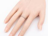 a woman ' s hand with a ring on it ' s finger
