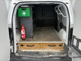 a white van with a fire extinguisor in the back of it