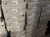 several stacks of boxes are stacked on top of each other in a warehouse