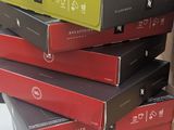 boxes of pizza stacked on top of each other on top of a table