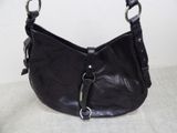 black leather purse with metal handles on a white surface