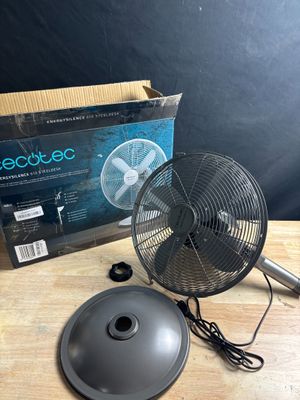 an electric fan sitting on top of a wooden table next to a box