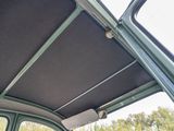 a close up of a car ' s roof with a window open