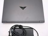 a black laptop with a power cord attached to it