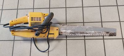 a chainsaw that is laying on a tiled floor