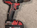 a close up of a cordless drill on the ground