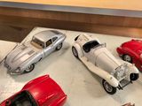 several toy cars are on display in a display case