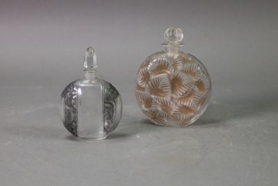 two small glass bottles sitting next to each other on a table