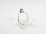 a close up of a ring on a white surface with a white background