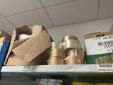 many rolls of tape on a shelf in a store