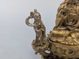 a statue of a woman sitting on top of a bowl
