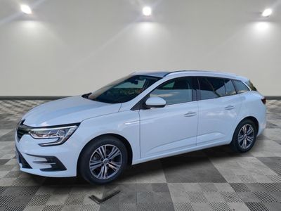 a white car is parked in a large room with a checkered floor