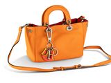 un sac à main orange auquel est accrochée une clé à la poignée