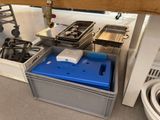 a blue box with a lid on it next to a stove