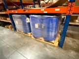 two blue barrels on the pallets in the warehouse