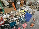 a large pile of tools and tools in a warehouse