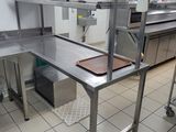 stainless steel work tables in a commercial kitchen with stainless steel appliances