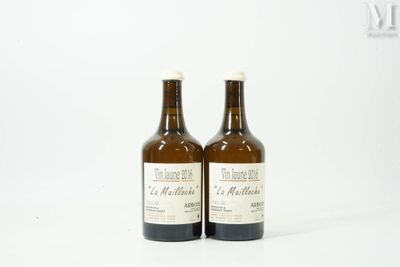 two bottles of wine sitting next to each other on a white surface