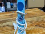 a toothbrush that is connected to a charger on a table