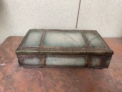 a glass box sitting on a table on the floor