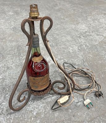 a bottle of liquor sitting on a table next to a lamp